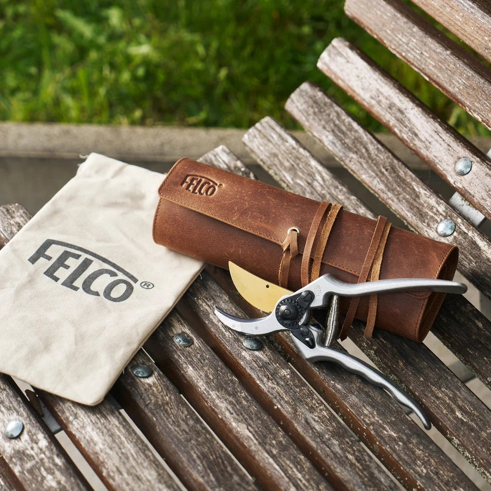 FELCO 2 – 80th Anniversary Special Edition with leather case on a wooden bench.